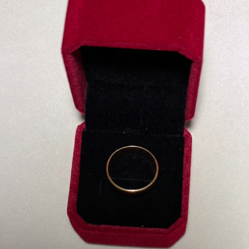 The ring's timeless aesthetic highlights the rich, warm hue of gold.