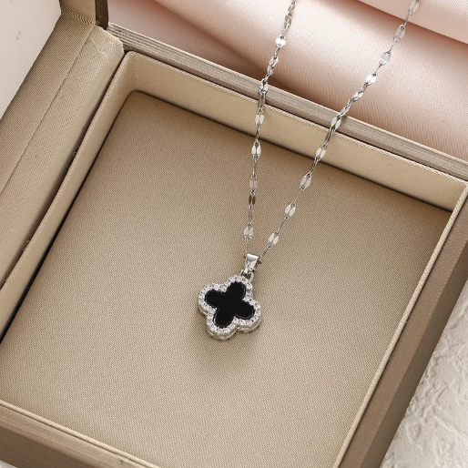 Cool white gold chain and pendant, with a black clover inlay. This necklace is suitable for various occasions, from casual wear to more formal events.
