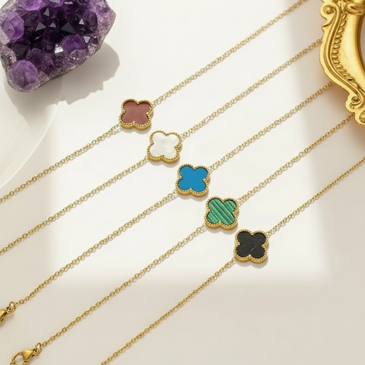 Set of gold bracelets with colorful clover-shaped pendants. The classic design, believed to symbolize luck, makes them popular as everyday wear or for special occasions.