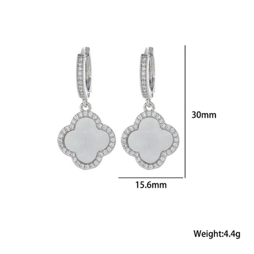 These earrings, with their refined design and shimmering details. are designed to dangle allowing the clover charm to swing gently with movement.