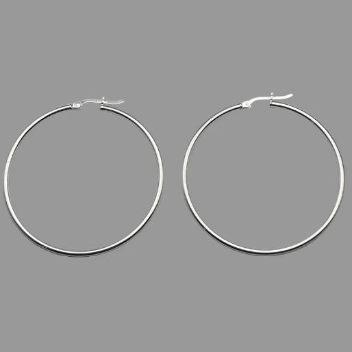 Their medium-large size makes them a prominent yet elegant accessory, suitable for various occasions and styles. The silver color and smooth finish are clearly visible, highlighting their quality and timeless appeal.