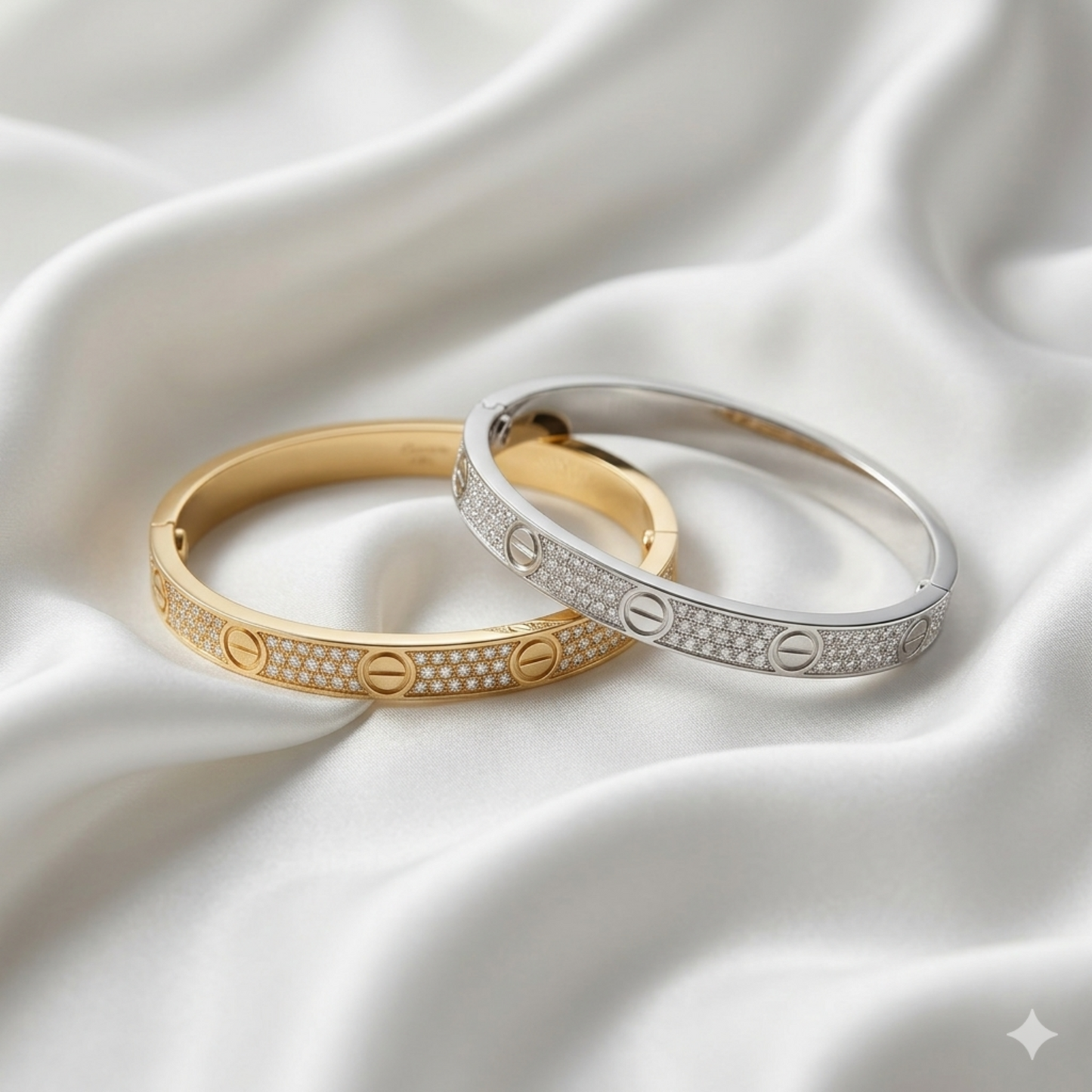 Gold and silver bracelets on a white satin background