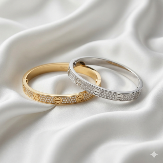 Gold and silver bracelets on a white satin background