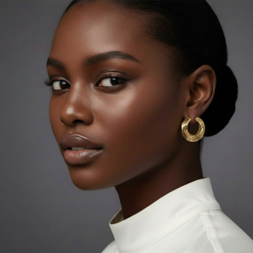 Gold hoop earrings with intricate designs on a gorgeous girl, showing the details