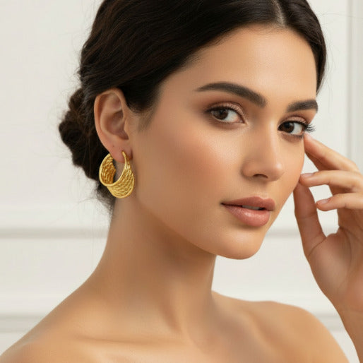 The visual details clearly highlight the sophisticates twisted design, where multiple strands of gold plated metal are interwoven.
