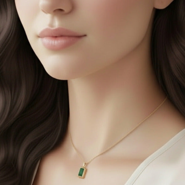 Beautiful and elegant gold plated necklace featuring a striking rectangular, emerald-cut green gemstone pendant.  This necklace is a classic example of fine jewelry, exuding timeless appeal.