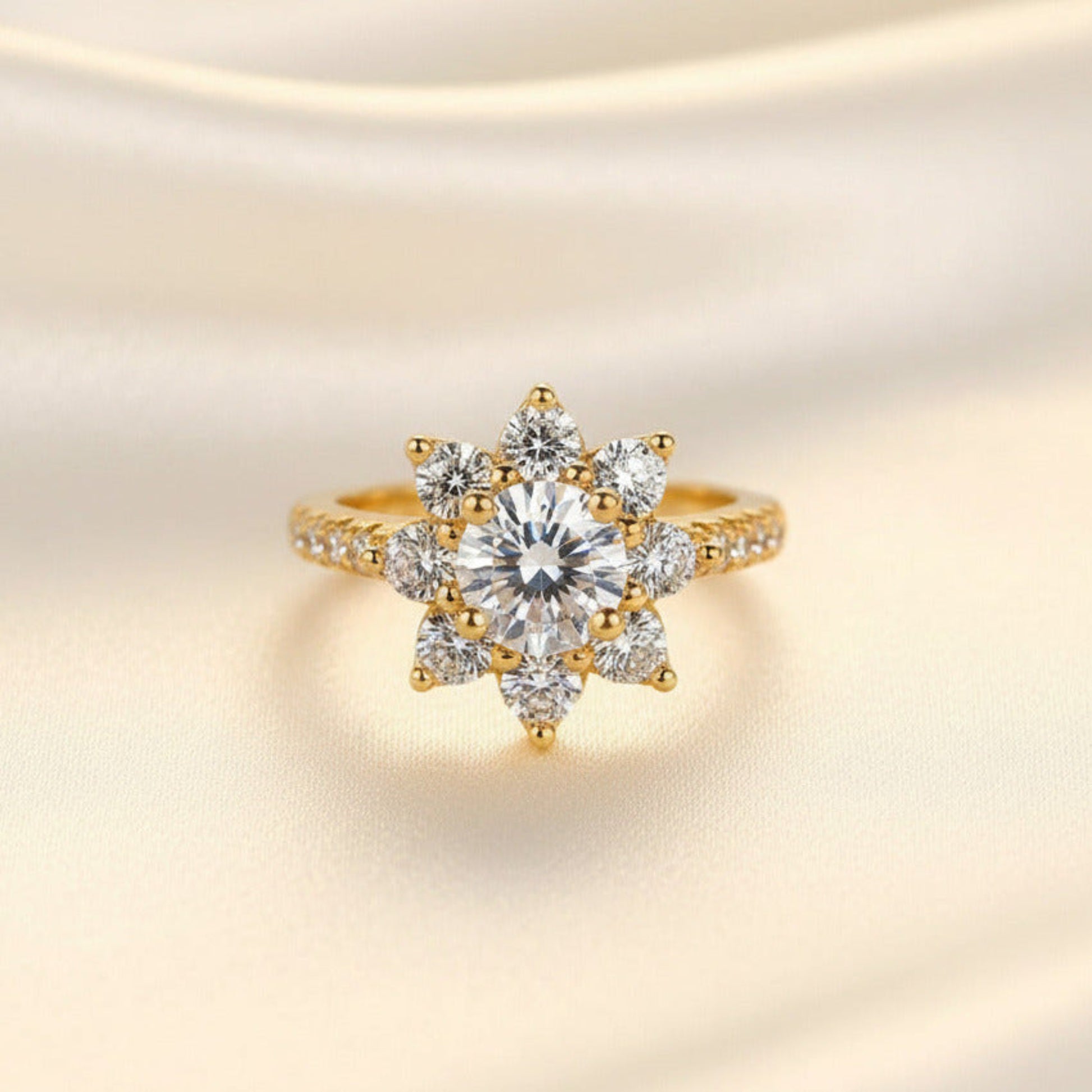 Gold ring with a gemstones in a flower pattern on a soft beige background