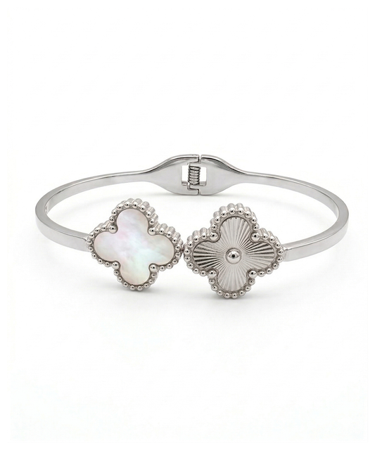 Silver bracelet with floral designs on a white background