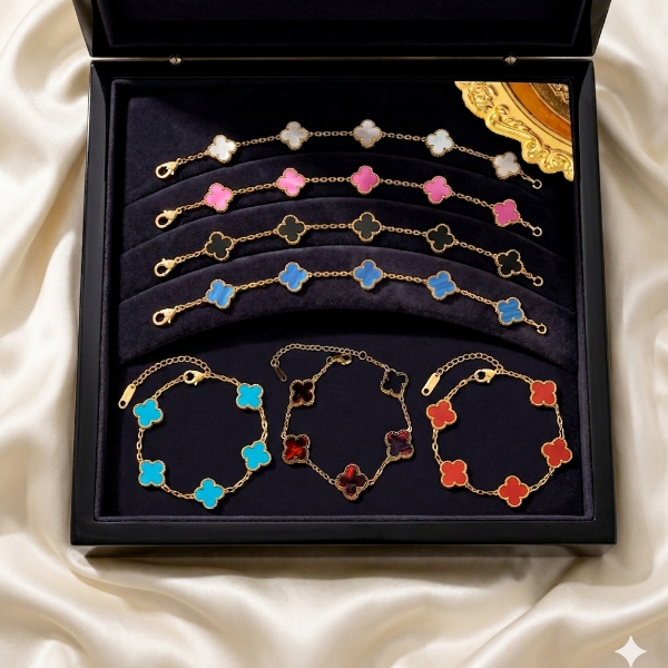 Set of colorful clover bracelets in a black box on a white fabric background