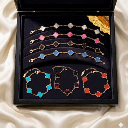 Set of colorful clover bracelets in a black box on a white fabric background