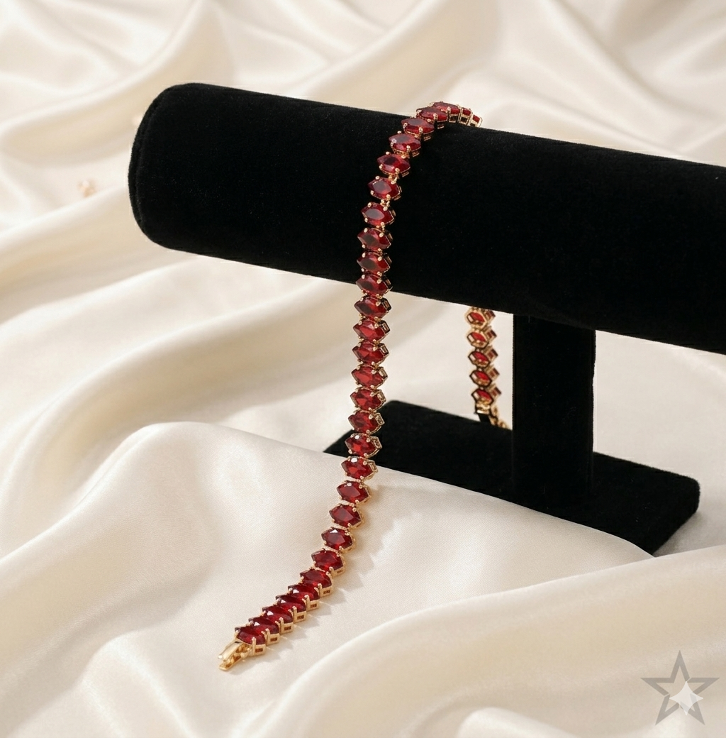 Red tennis beaded necklace on a black stand with a white fabric background