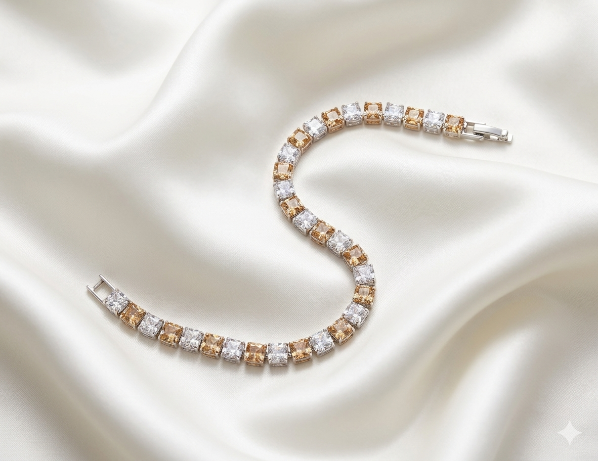 Diamond and champagne tennis bracelet on a satin surface