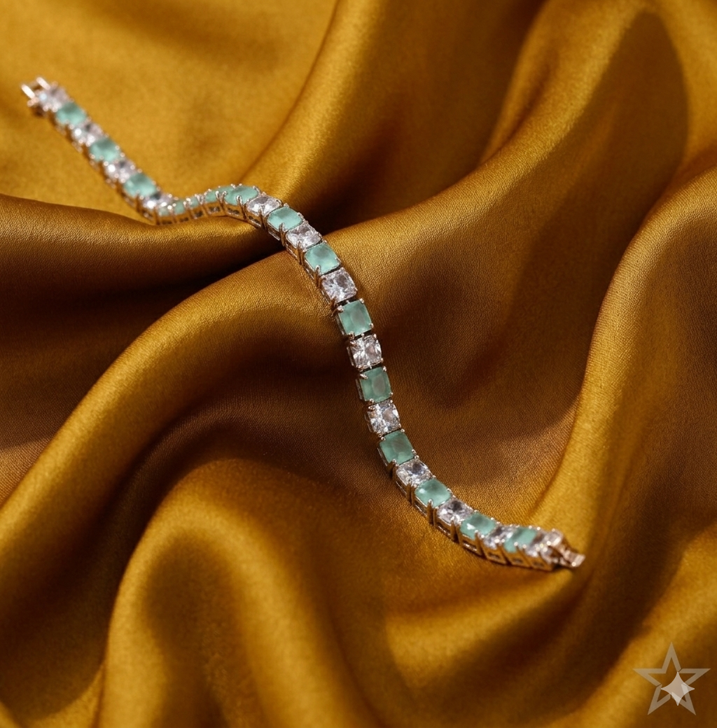 Emerald and diamond tennis bracelet on a gold satin background