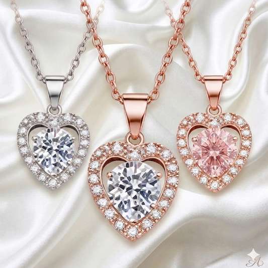 Three heart-shaped moissanite diamond pendants in silver, rose gold, and pink gold on a white background.