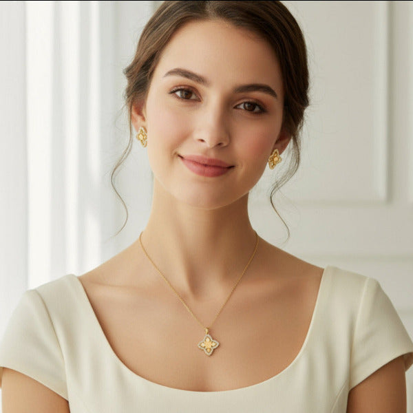 This jewelry set is designed with a textured four-petal, clover-like motif, often associated with good luck and nature. In Gold tone finish, this. set. has a visually rich and luxurious. appearance, elevating any outfit.