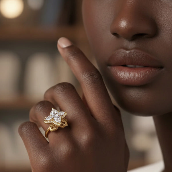 Close-up of a hand wearing a gold ring, featuring a spinner sophisticated flower design, with clear stones. Its refined design makes it suitable for everyday wear while offering functional stress relief