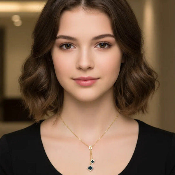 Elegant double clover pendant necklace featuring a delicate gold-toned chain, and showcasing two distinct clover-shape pendants, one slightly larger than the other. Here shown in black enamel finished.