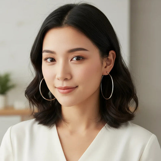 This is a pair of classic, round hoop earrings crafted from 18K Gold plating Titanium Steel. They feature a simple, polished design, giving them a sleek and versatile appearance. 