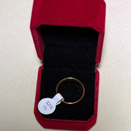 The ring's timeless aesthetic highlights the rich, warm hue of gold.