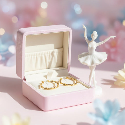 These are a pair of elegant gold-colored hoop earrings featuring a distinctive twisted design along their circumference. 