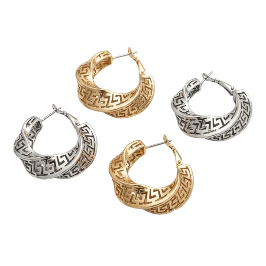 Four hoop earrings in gold and silver on a white background