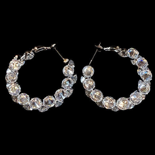 Pair of crystal hoop earrings on a black background