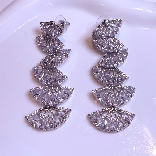 Pair of dangle silver earrings on a white background