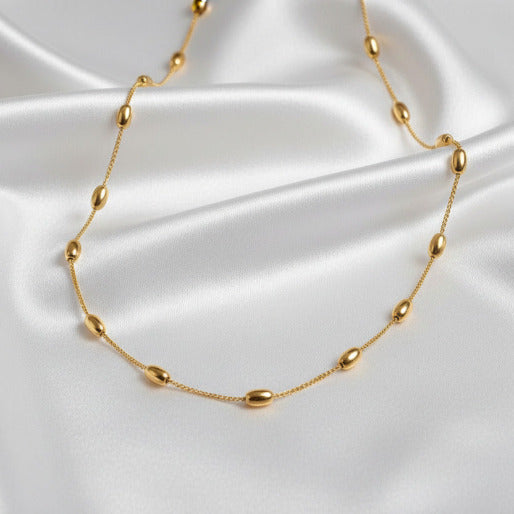 Gold necklace on a white backround