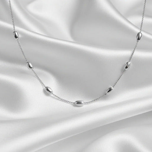 Silver necklace  against a white background