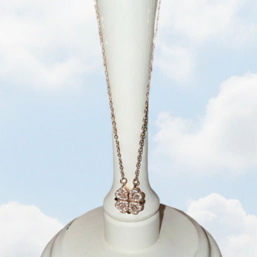 The pendant is suspended from a delicate link chain,  and the combination of metallic finishes and stone embellishment elevates the necklace beyond a simple charm, adding a refined touch to its convertible design.