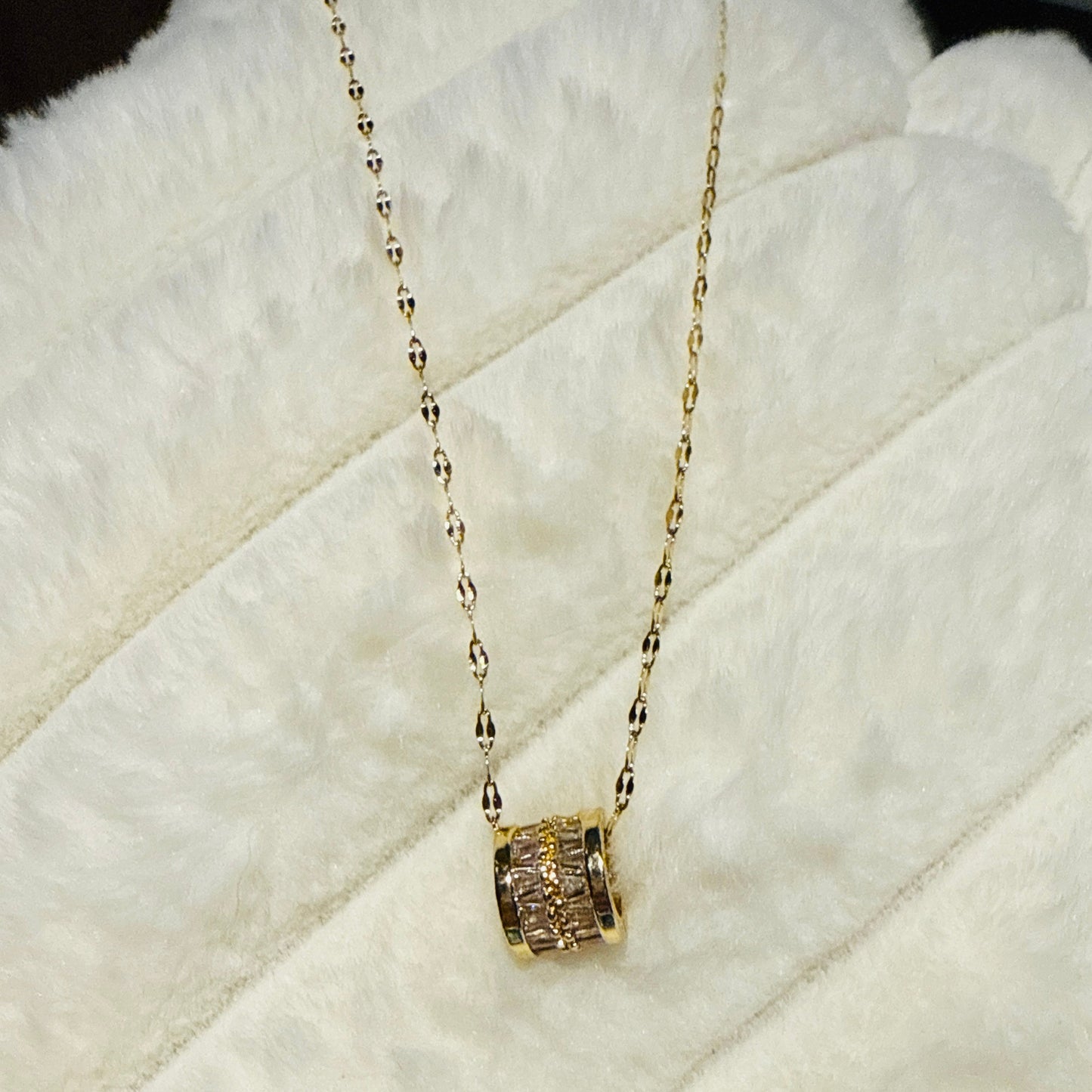 This piece utilizes 18K gold plated over titanium offering a luxurious look at an accessible price, with zirconia providing significant sparkle and clarity.