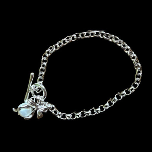Silver tone bracelet, platinum plated with charms and toggle clasp. Timeless and sophisticate,