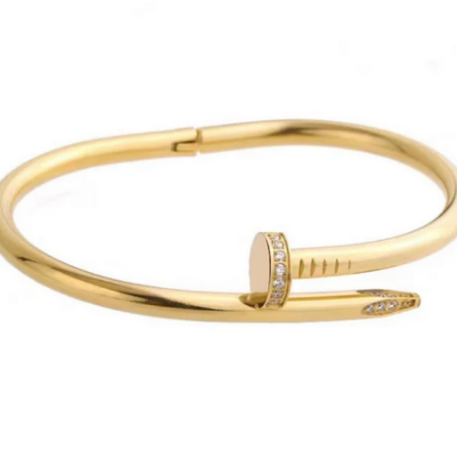 A discrete hinge mechanism is visible on the underside, allowing the wearer to open and close the bangle.