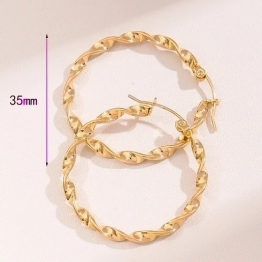 The twisting creates multiple reflective facets, giving them a shimmering, almost diamond cut appearance that catches the light beautifully. Measuring 35mm, they fasten securely with a hinged post closure.