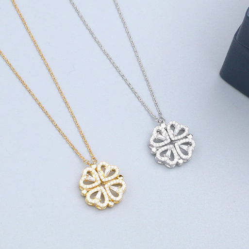 These are two magnetic clover necklaces, one in a radiant gold tone and the other in a classic silver tone, both showcasing the closed, circular four-leaf configuration. They can open revealing four individual hearts in a linear configuration.