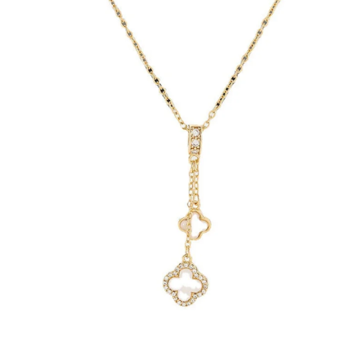 Gold necklace with white double clover pendant. The design offers a sophisticated look suitable for adding a touch of charm and look to any outfit.