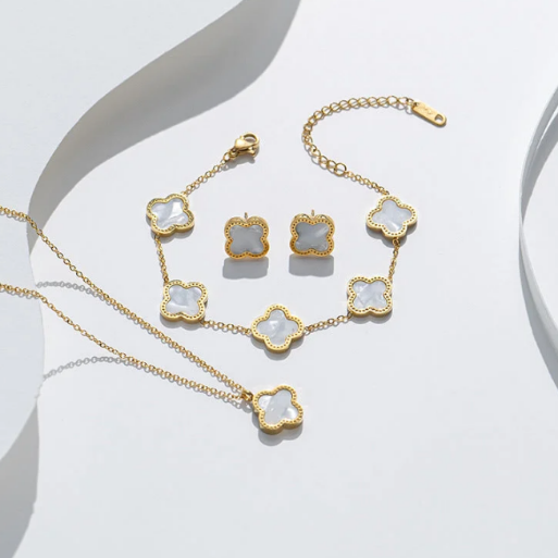 This jewelry set includes a matching three-piece jewelry featuring a necklace with. single clover pendant, a. bracelet adorned with multiple clover links, and a pain of stud earrings, each featuring a clover design.  This set is designed to be worn together for a complete, coordinated style or individually for a. more subtle touch.