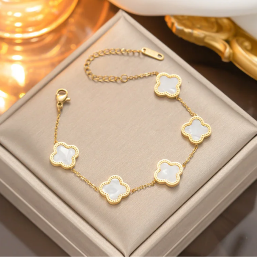 Elegant chain bracelet featuring 5 distinct clover-shaped charms evenly space along its length.  It has a delicate gold chain,  a lobster clasp, and an adjustable extender chain for a customized fit.