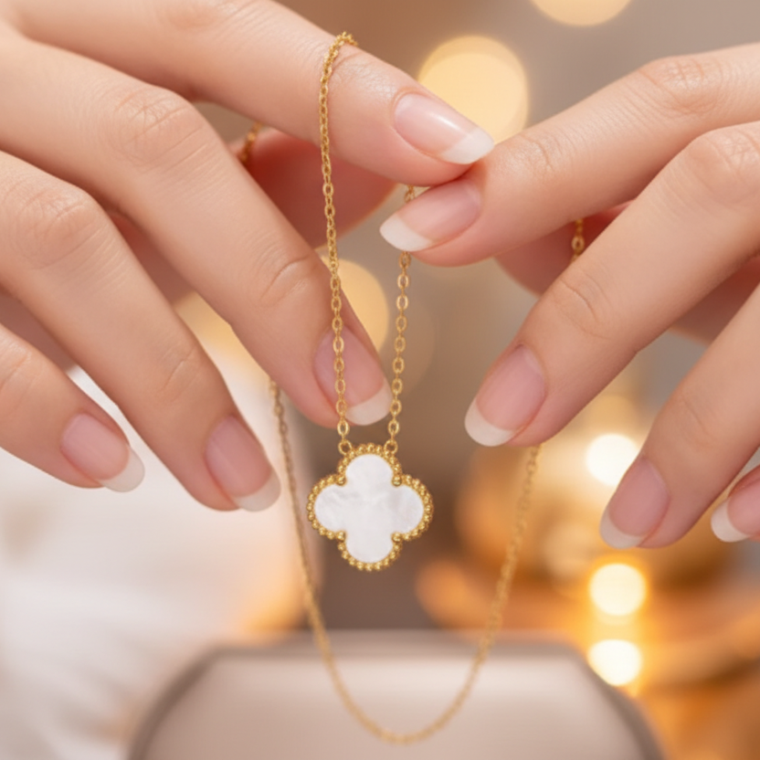 This delicate necklace features a single white, four-leaf clover shaped pendant, often. associated with luck. It serves as an elegant accessory , suitable for various occasions, and its timeless design makes it a popular choice.