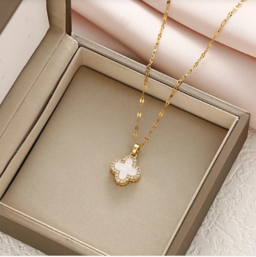 Delicate gold plated chain and a distinctive white clover charm, exquisitely outlined with a border of sparkling clear rhinestones.