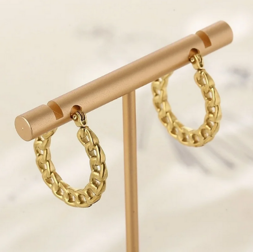 Gold chain Cuban hoop earrings on a gold stand 