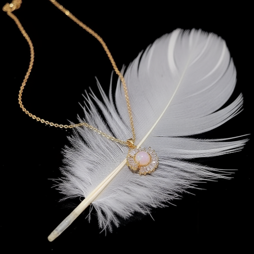 The pendant showcases a central luminous pearl encircled by multiple radiant baguette-cut crystals, meticulously arranged to create a sparkling, flower like or sun-ray effect.