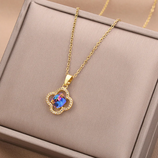 The pendant is suspended from a fine, gold colored chain, making it a versatile accessory suitable for enhancing various outfits. 