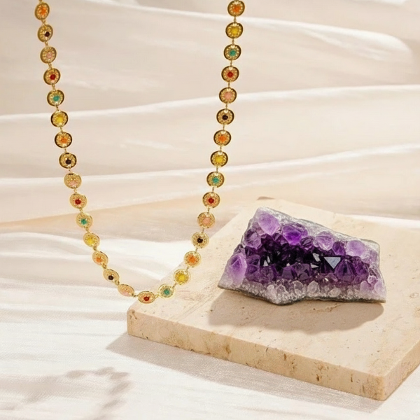 Necklace with multicolored enamel dots on a gold toned chain. These dot come in various colors, including red, green, yellow, orange and blue. creating a playful and eye catching aesthetic,