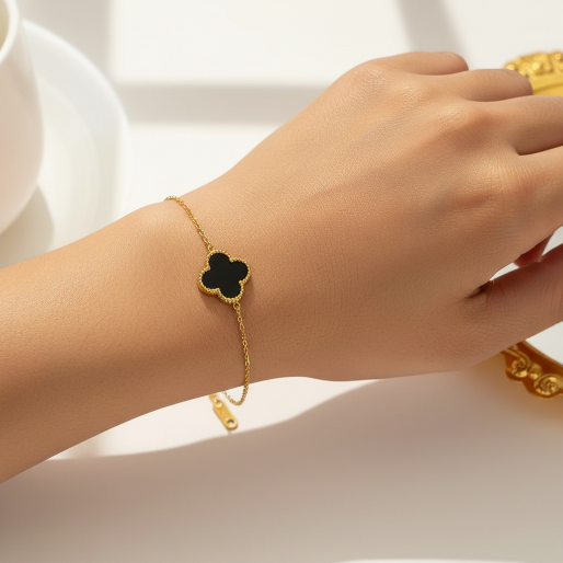 Black clover gold bracelet. The clover has a smooth, glossy black inlay, meticulously framed by a fine beaded gold border.