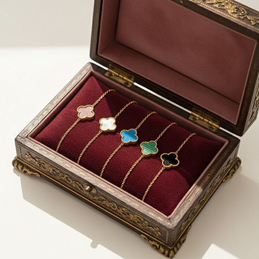 Collection of five elegant chain bracelets, each featuring a distinct clover-shaped charm in various vibrant colors: pink, white, blue, green (with a subtle striped pattern), and black. This charm often symbolizes good luck, and offers a touch of sophistication to any ensemble.