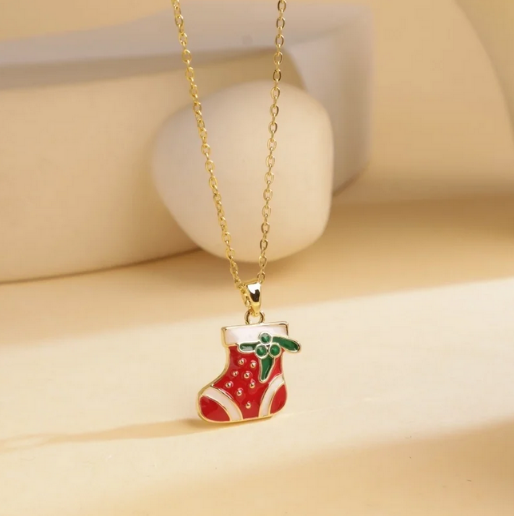 Red stocking enamel pendant on a dainty gold tone chain.