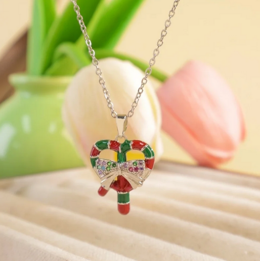 Candy cane enamel pendant on a silver tone chain.