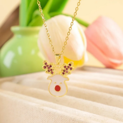 White reindeer enamel pendant on a dainty gold tone chain.