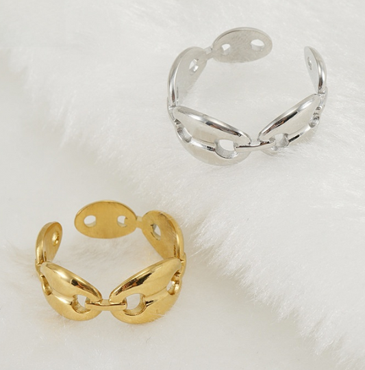 Gold and silver mariner open rings on a white fabric background. These rings are 18K gold finished, and crafted in titanium, giving them durability and luxury appearance